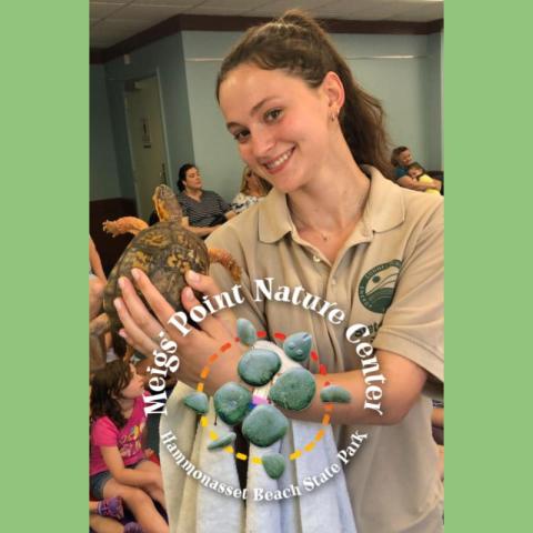 Meigs Point staff member holding a turtle 