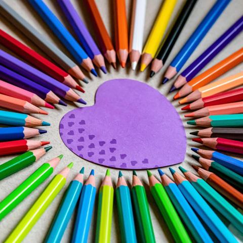 Crafternoons - Purple heart cutout surrounded by a rainbow of colored pencils