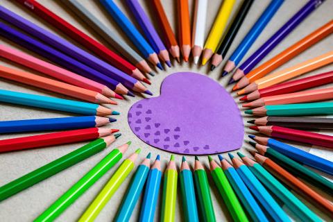 purple heart surrounded by colored pencils