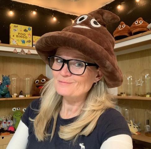 Women wearing poop emoji hat 